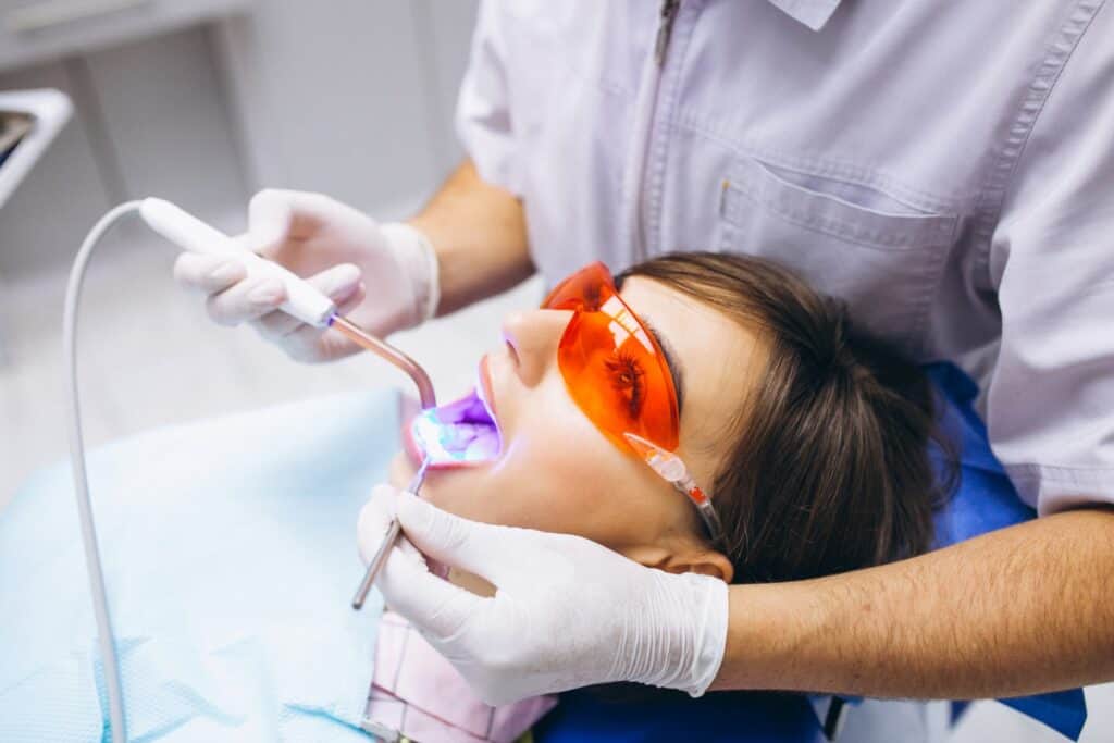 Young Woman Undergoing Teeth Whitening Procedure